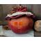 A candle lights the smile of this fall apple decoration. It is a real gourd with a happy face carved into it. This gourd is named Apple.